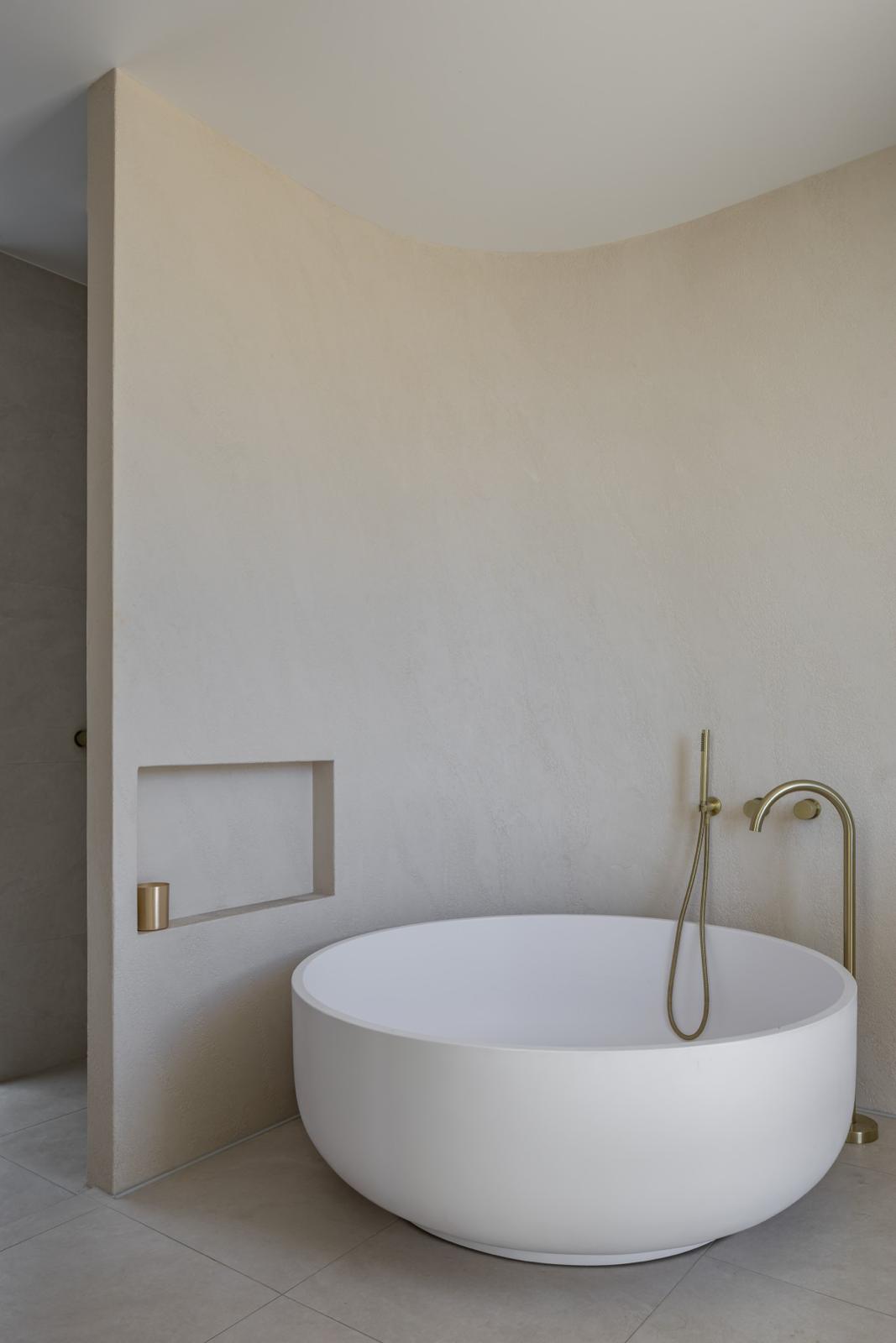 Round freestanding bath & floor mixer — Bathroom Renovations plumbing job in Kiama by a licensed Shellharbour plumber