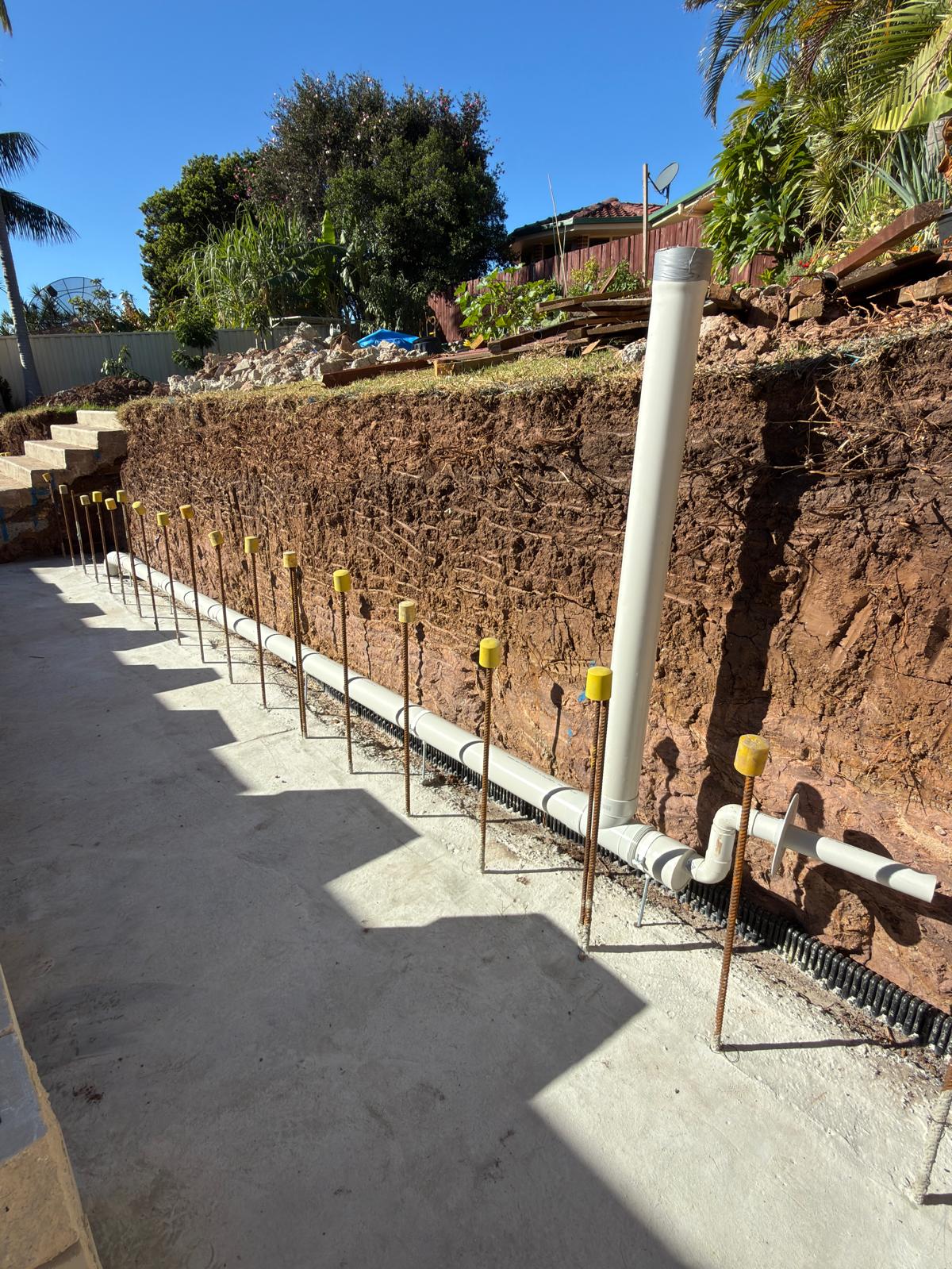 Retaining wall — agg drain & stormwater riser — plumbing work completed in Warilla by Shellharbour Plumbing (licensed Illawarra plumber)