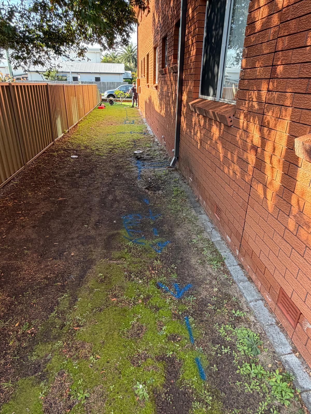 Stormwater set-out — side of unit block — plumbing work completed in Warilla by Shellharbour Plumbing (licensed Illawarra plumber)