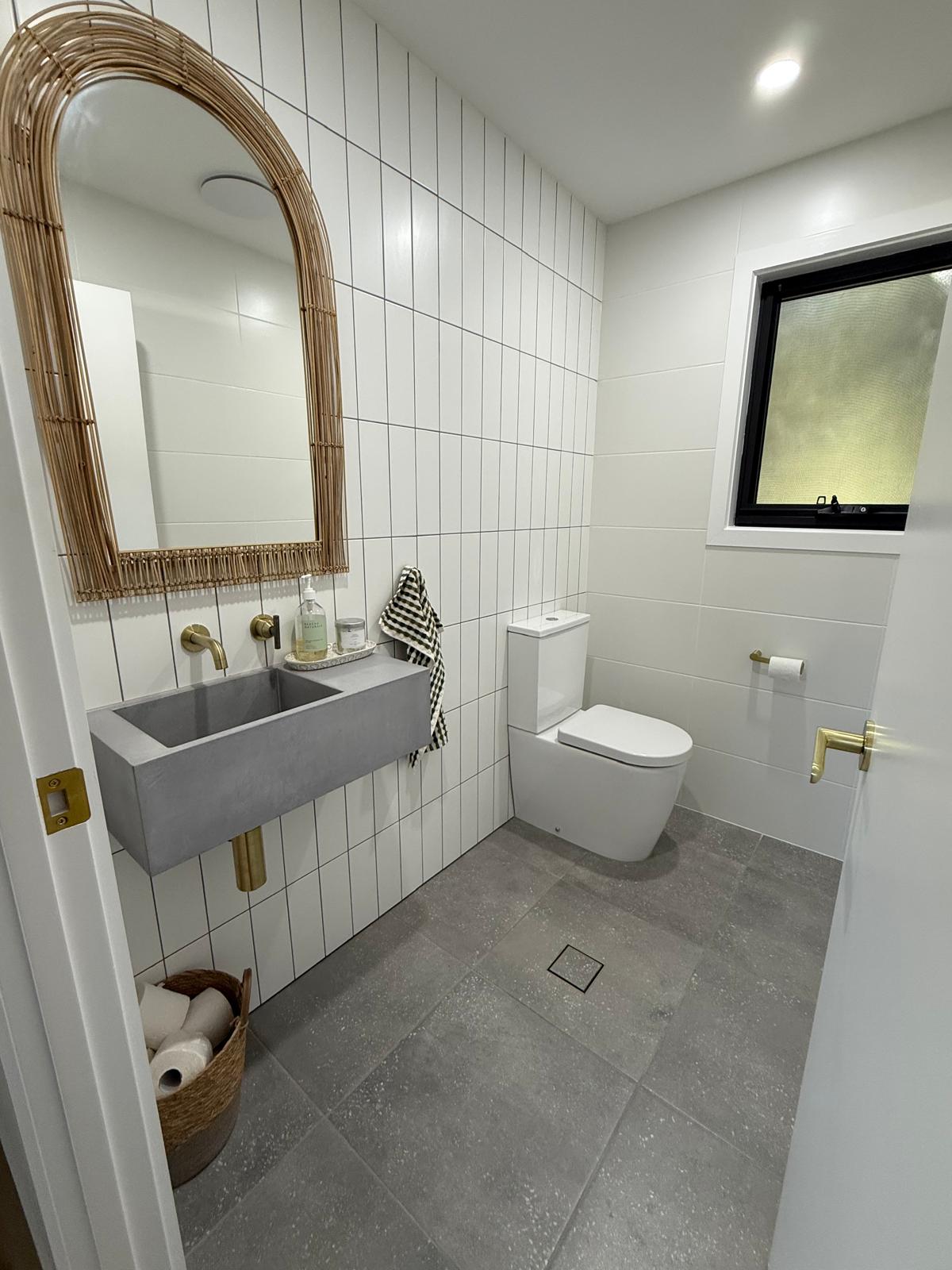 Powder room — concrete basin & brass tapware — plumbing work completed in Shellharbour by Shellharbour Plumbing (licensed Illawarra plumber)