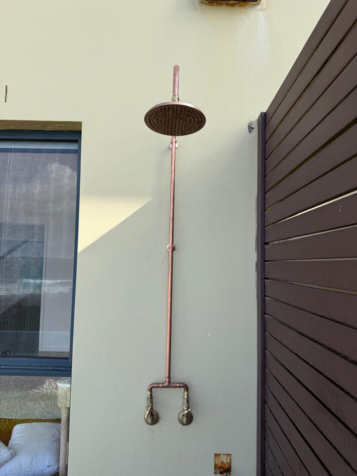 Copper outdoor shower — rainhead & dual taps — General Plumbing plumbing job in Gerringong by a licensed Shellharbour plumber