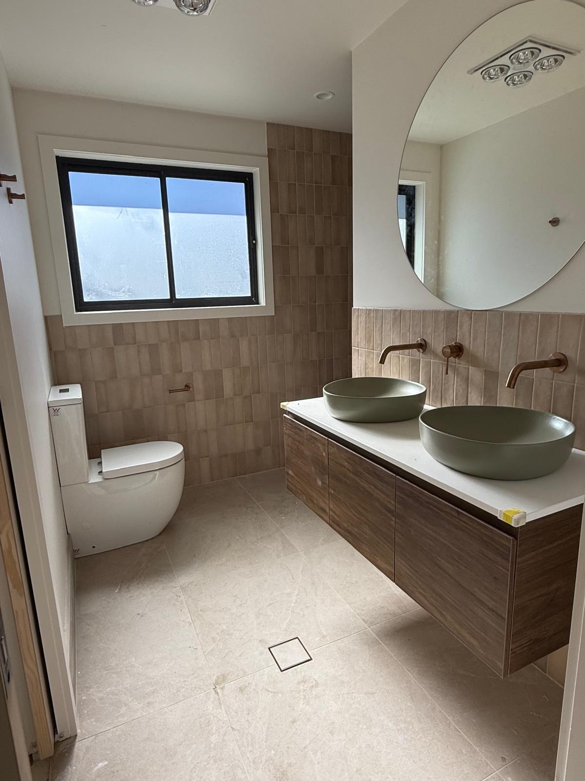 Double vanity with sage vessel basins — plumbing work completed in Oak Flats by Shellharbour Plumbing (licensed Illawarra plumber)