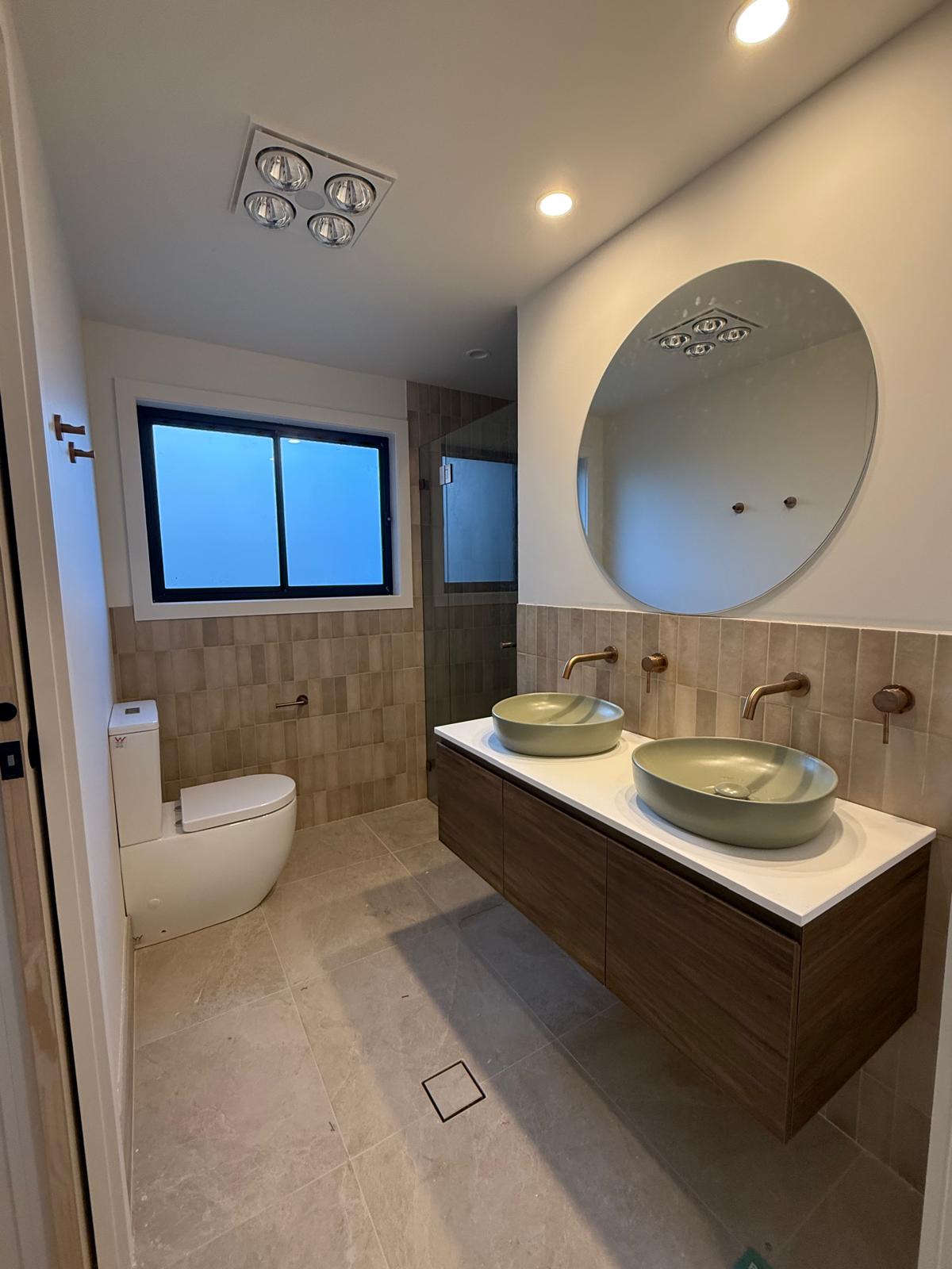 Family bathroom — sage basins & brass — plumbing work completed in Shellharbour by Shellharbour Plumbing (licensed Illawarra plumber)