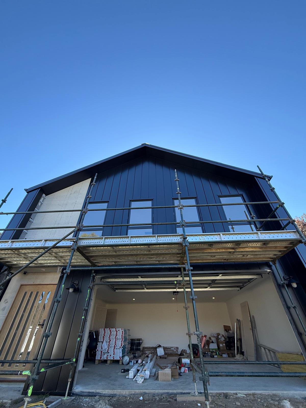 New build — black-clad two-storey — plumbing work completed in Kiama Downs by Shellharbour Plumbing (licensed Illawarra plumber)