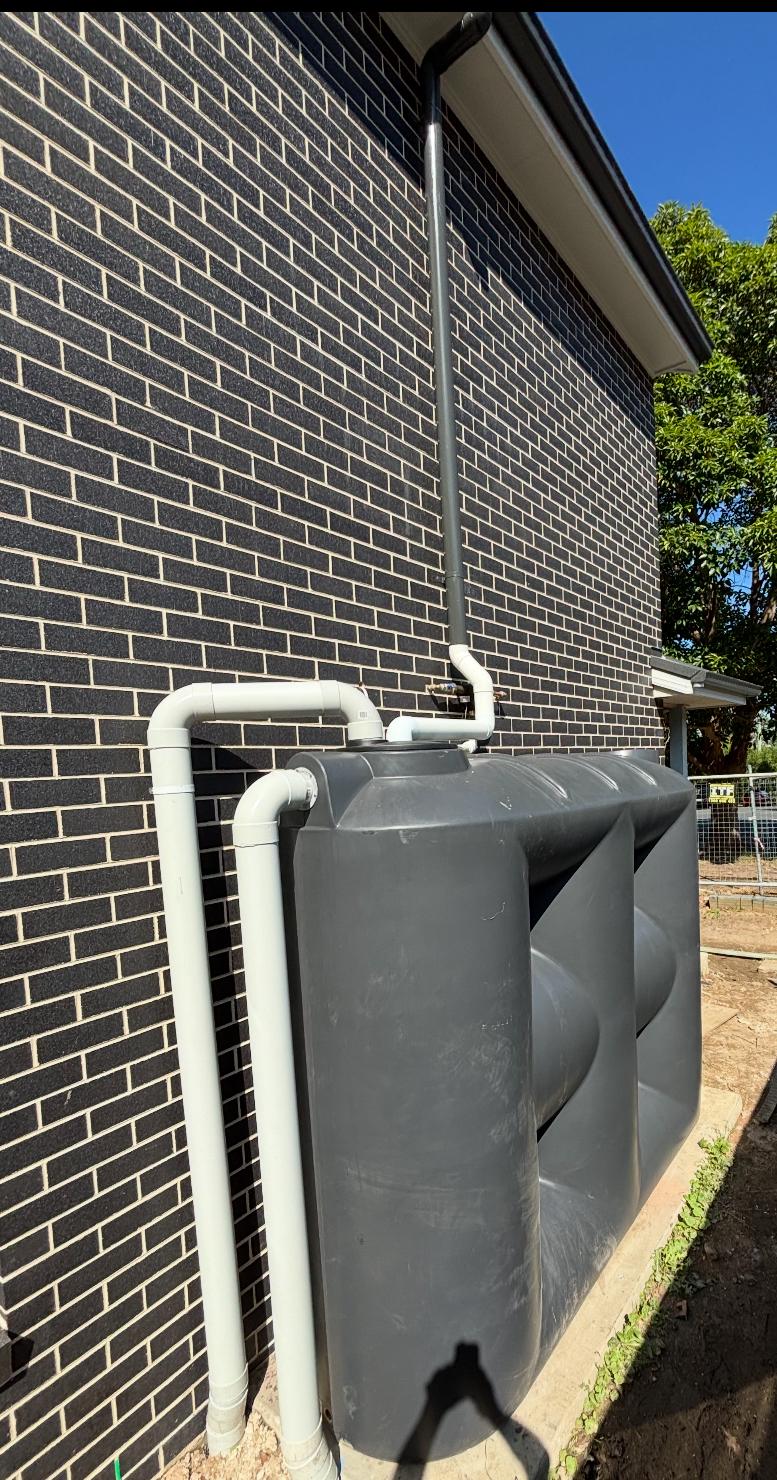 Poly rainwater tank & overflow — plumbing work completed in Warilla by Shellharbour Plumbing (licensed Illawarra plumber)