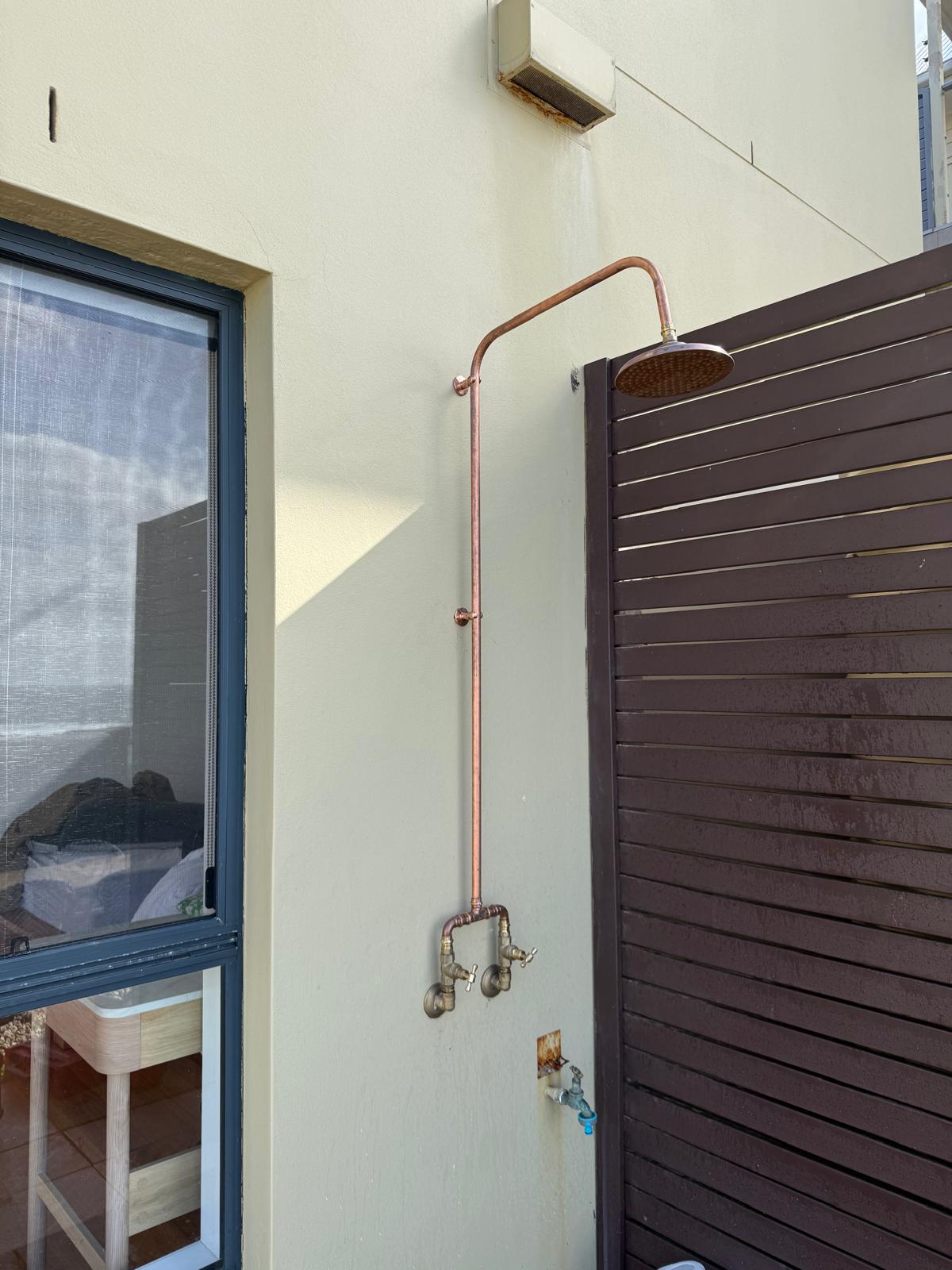 Copper outdoor shower — courtyard side view — plumbing work completed in Gerringong by Shellharbour Plumbing (licensed Illawarra plumber)